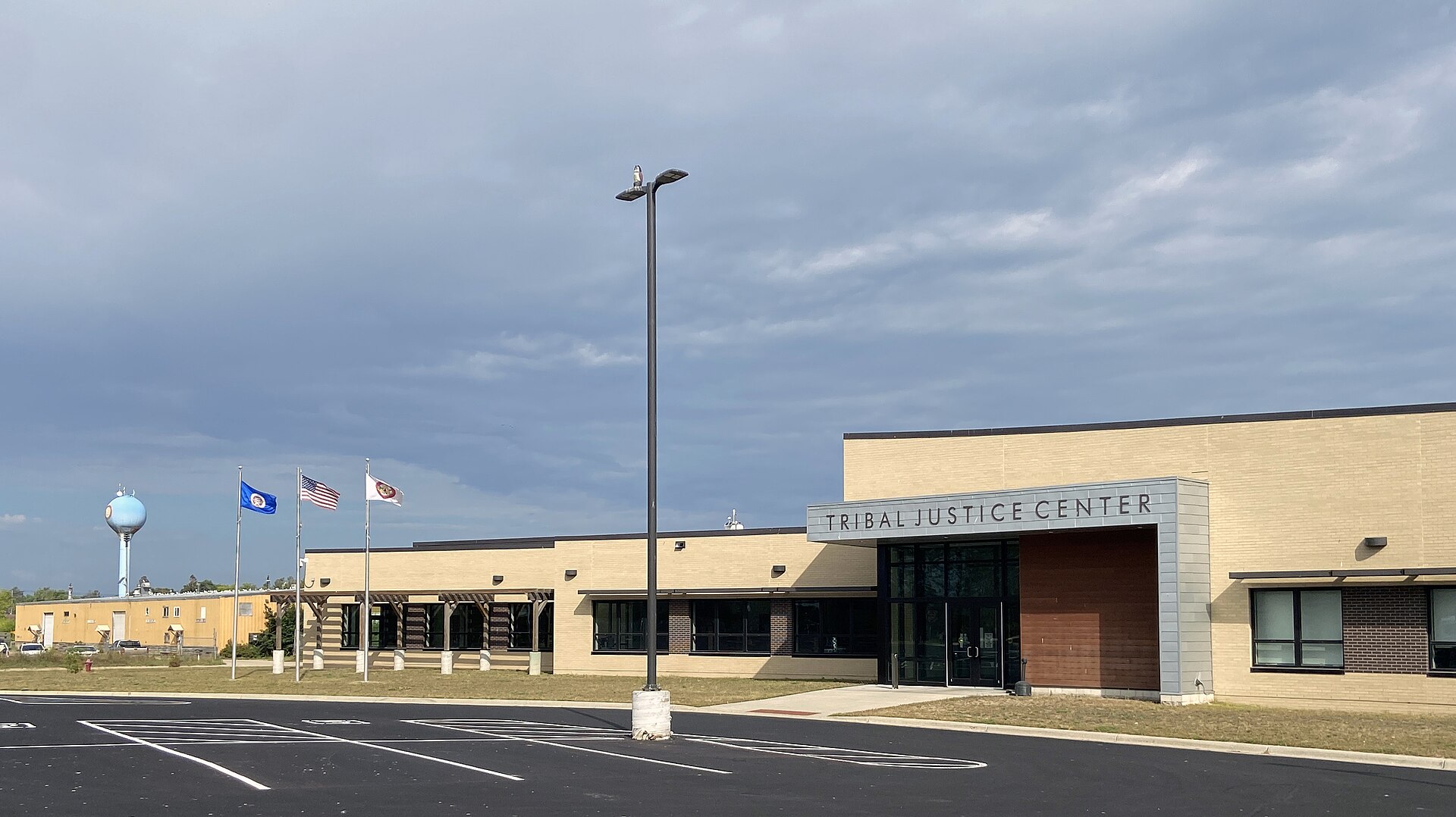 The Tribal Justice Center of the Leech Lake Band of Ojibwe in Cass Lake, Minnesota, with U.S., Minnesota and tribal flags flying out front
